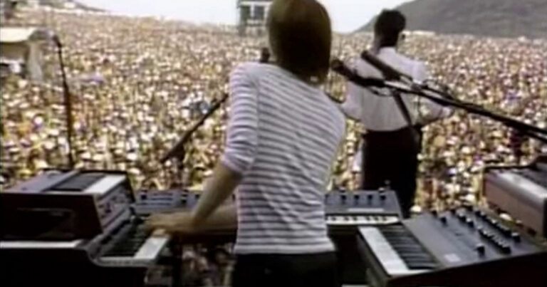 > *Greg Hawkes of The Cars at his multi-tier keyboard rig on stage at the US Festival, September 4, 1982, with the desert crowd of two hundred thousand stretching out toward the San Bernardino mountains.*