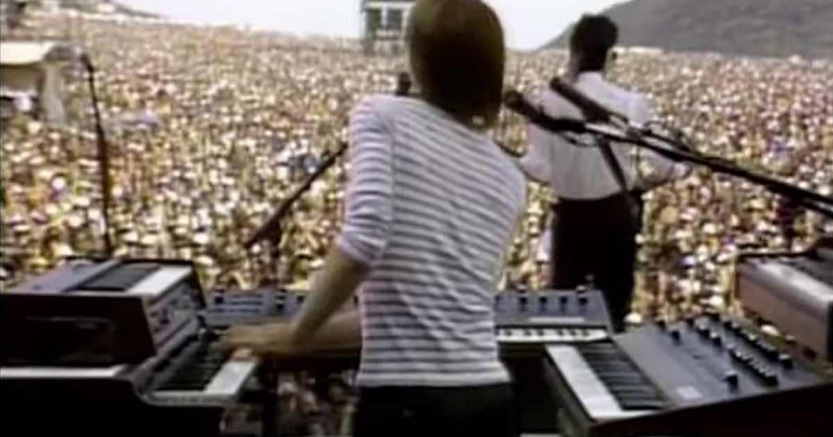 > *Greg Hawkes of The Cars at his multi-tier keyboard rig on stage at the US Festival, September 4, 1982, with the desert crowd of two hundred thousand stretching out toward the San Bernardino mountains.*