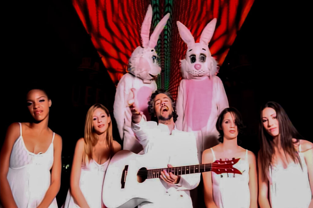 The Flaming Lips Do You Realize Music Video with Wayne Coyne Singing with White Guitar Surrounded by Females in White Clothes and two men in Bunny Costumes